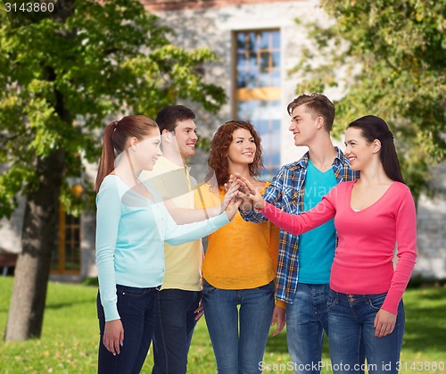 Image of group of smiling teenagers over campus background