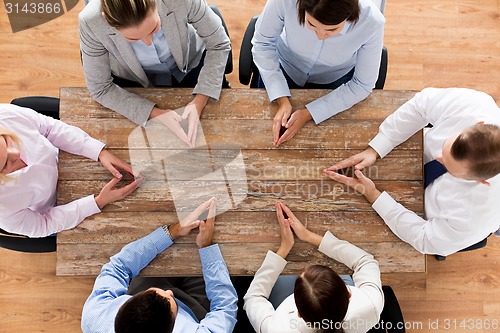 Image of close up of business team sitting at table
