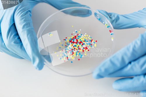 Image of close up of scientist hands holding chemical cure