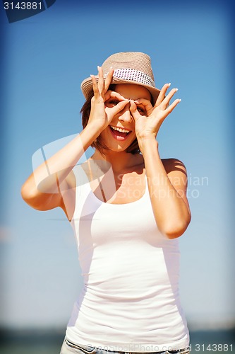 Image of girl making funny faces on the beach