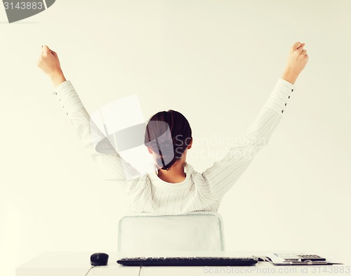 Image of woman from the back with raised hands