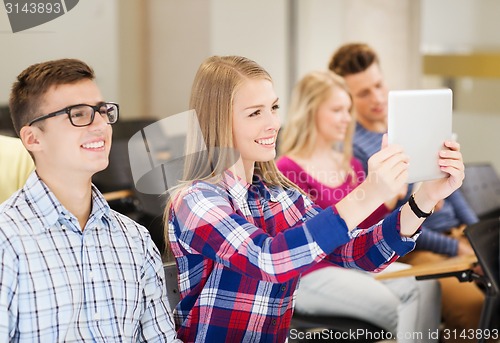Image of group of smiling students with tablet pc