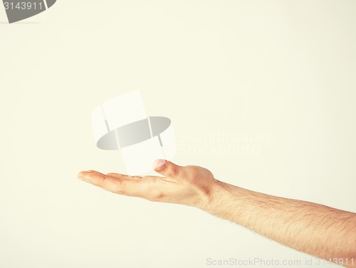 Image of mans hand showing something