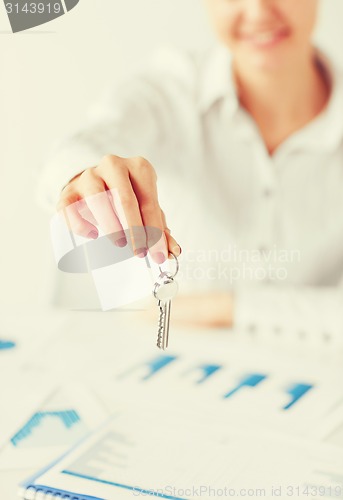 Image of woman hand holding house keys