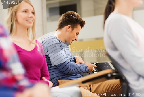 Image of group of smiling students in lecture hall