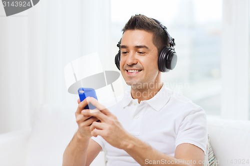 Image of happy man with smartphone and headphones