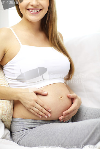 Image of close up of happy pregnant woman at home