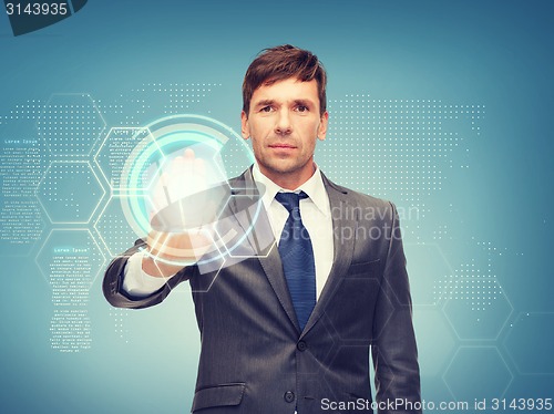 Image of attractive buisnessman working with virtual screen