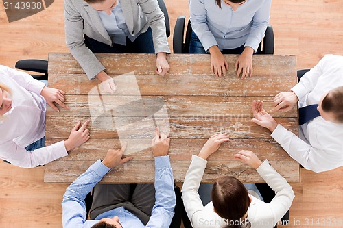 Image of close up of business team sitting at table