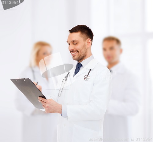 Image of smiling male doctor with clipboard and stethoscope