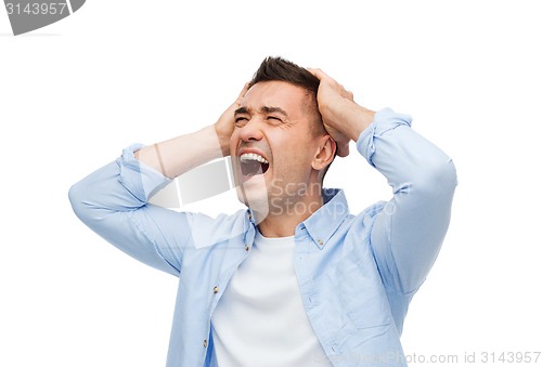 Image of unhappy man with closed eyes touching his forehead