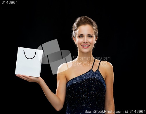 Image of smiling woman with white blank shopping bag