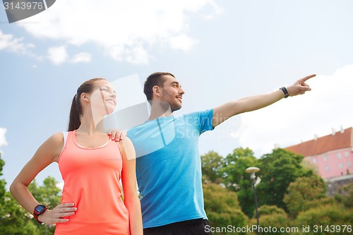 Image of two smiling people outdoors