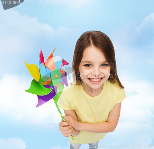 Image of smiling child with colorful windmill toy