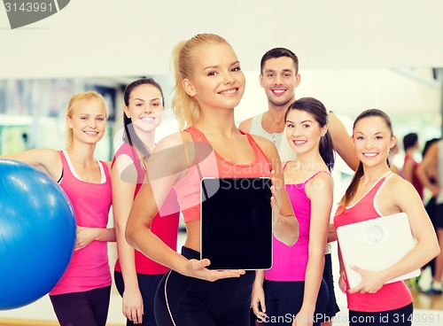 Image of smiling woman showing tablet pc blank screen