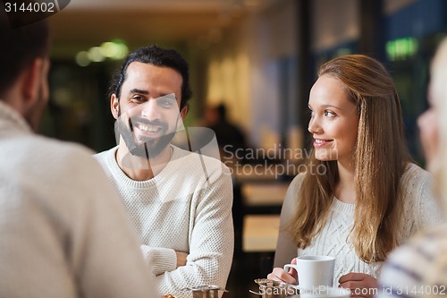 Image of happy friends meeting and drinking tea or coffee