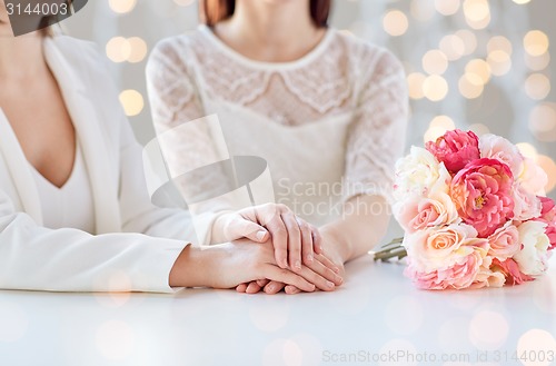 Image of close up of happy lesbian couple with flowers