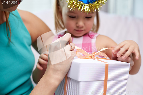 Image of happy mother and little girl with gift box