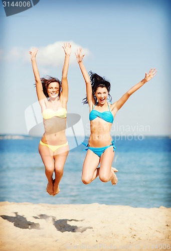 Image of girls jumping on the beach