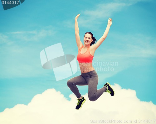 Image of sporty teenage girl jumping in sportswear