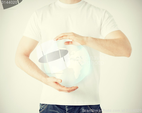 Image of man hands holding sphere globe
