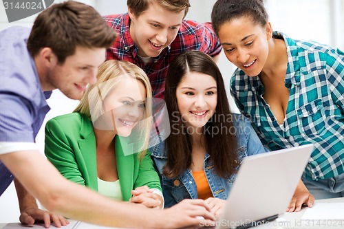 Image of students looking at tablet pc in lecture at school