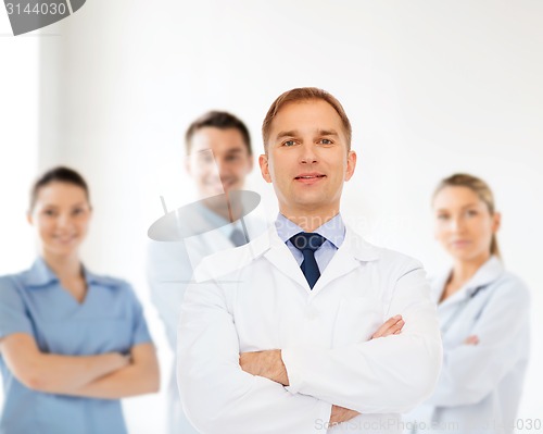 Image of smiling male doctor in white coat