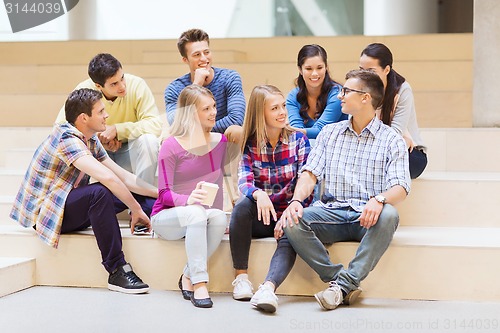 Image of group of smiling students with paper coffee cups