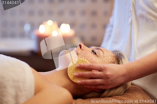 Image of close up of woman having face massage in spa
