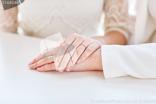 Image of close up of happy married lesbian couple hugging