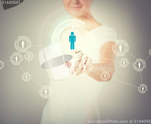 Image of businesswoman pressing button with contact