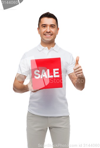 Image of smiling man with red sale sigh showing thumbs up