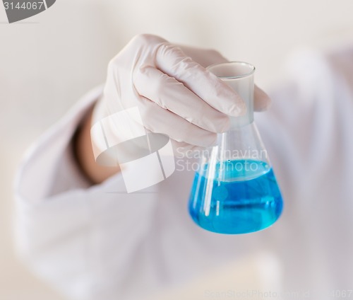 Image of close up of hand with flask 