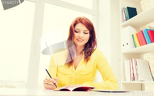 Image of smiling businesswoman or student with tablet pc