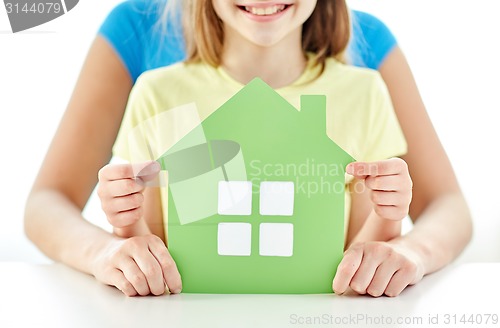 Image of close up of woman and girl hands with paper house