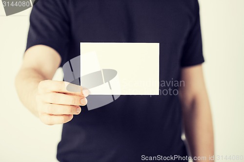 Image of man hand with blank paper