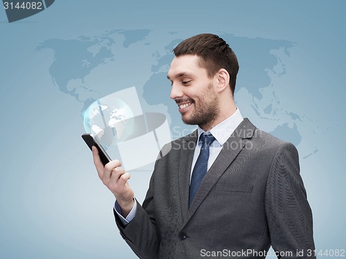 Image of young smiling businessman with smartphone