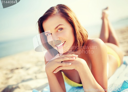 Image of girl sunbathing on the beach