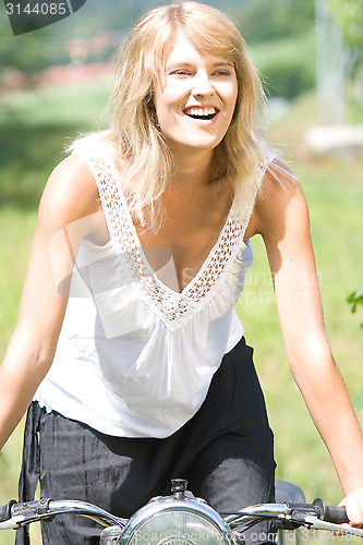 Image of Young woman on motorcycle