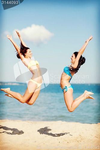 Image of girls jumping on the beach