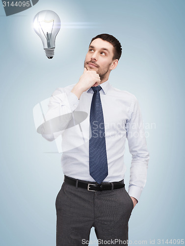 Image of handsome businessman looking up