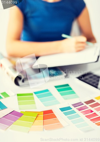 Image of woman working with color samples for selection