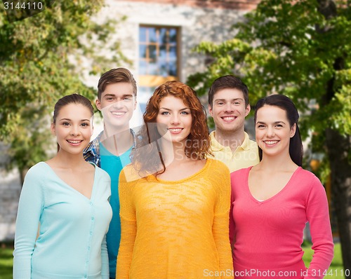 Image of group of smiling teenagers over campus background