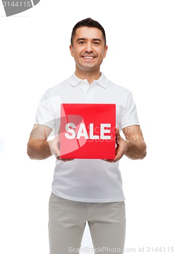 Image of smiling man with red sale sigh