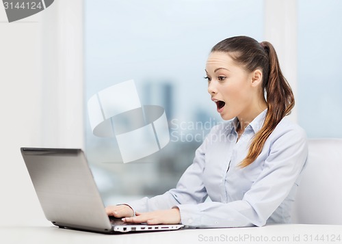 Image of surprised businesswoman with laptop