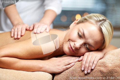 Image of close up of woman lying and having massage in spa