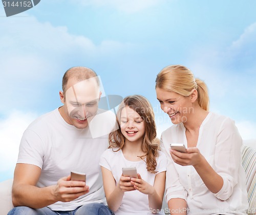 Image of happy family with smartphones