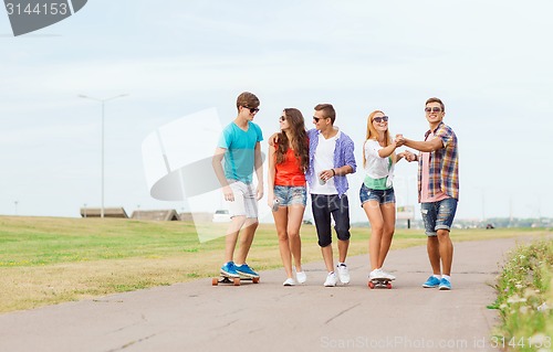 Image of group of smiling teenagers with skateboards