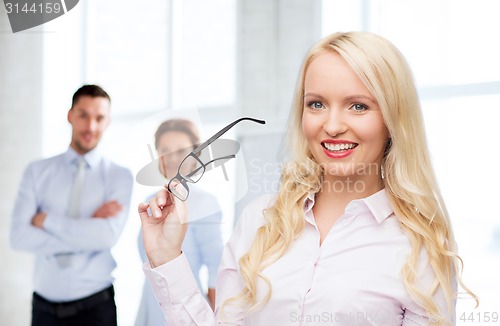 Image of smiling businesswoman or secretary in office