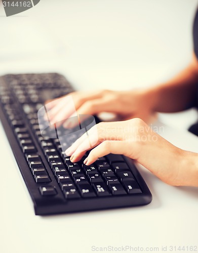 Image of woman hands typing on keyboard